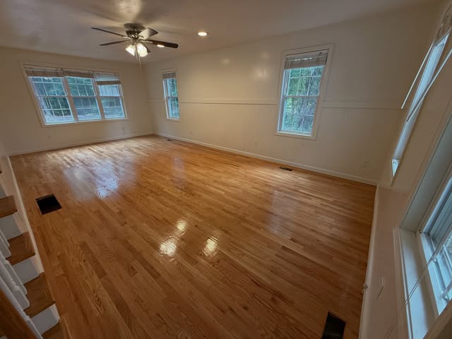Light-filled room with restored hardwood floors in Mashpee